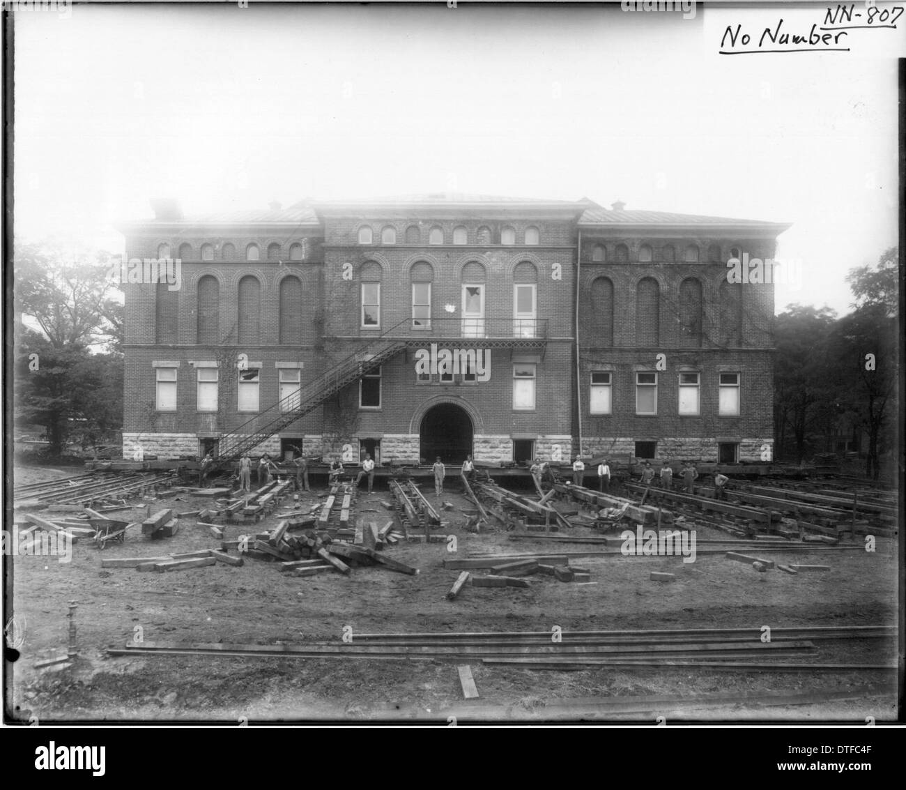 The photograph depicts the relocation of the Herron Gymnasium building in 1922 at Miami University in Oxford, Ohio. The historical image showcases the logistical efforts to move the structure, an important event in the university’s history. The gymnasium was relocated to accommodate campus expansion while preserving its architectural significance. Stock Photo