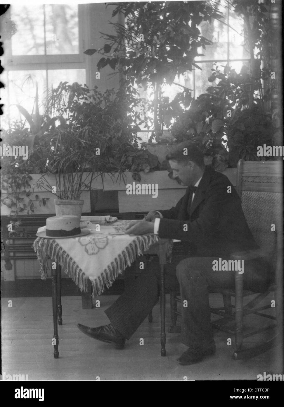 Man at table in sunroom at Oxford Retreat n.d. Stock Photo