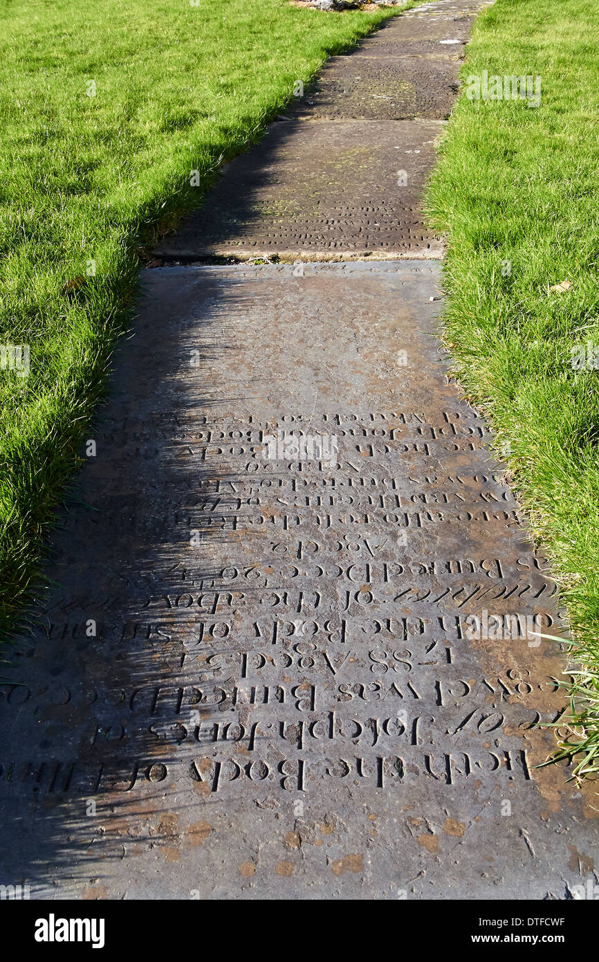 A path in a Church Yard made of old gravestones. Stock Photo