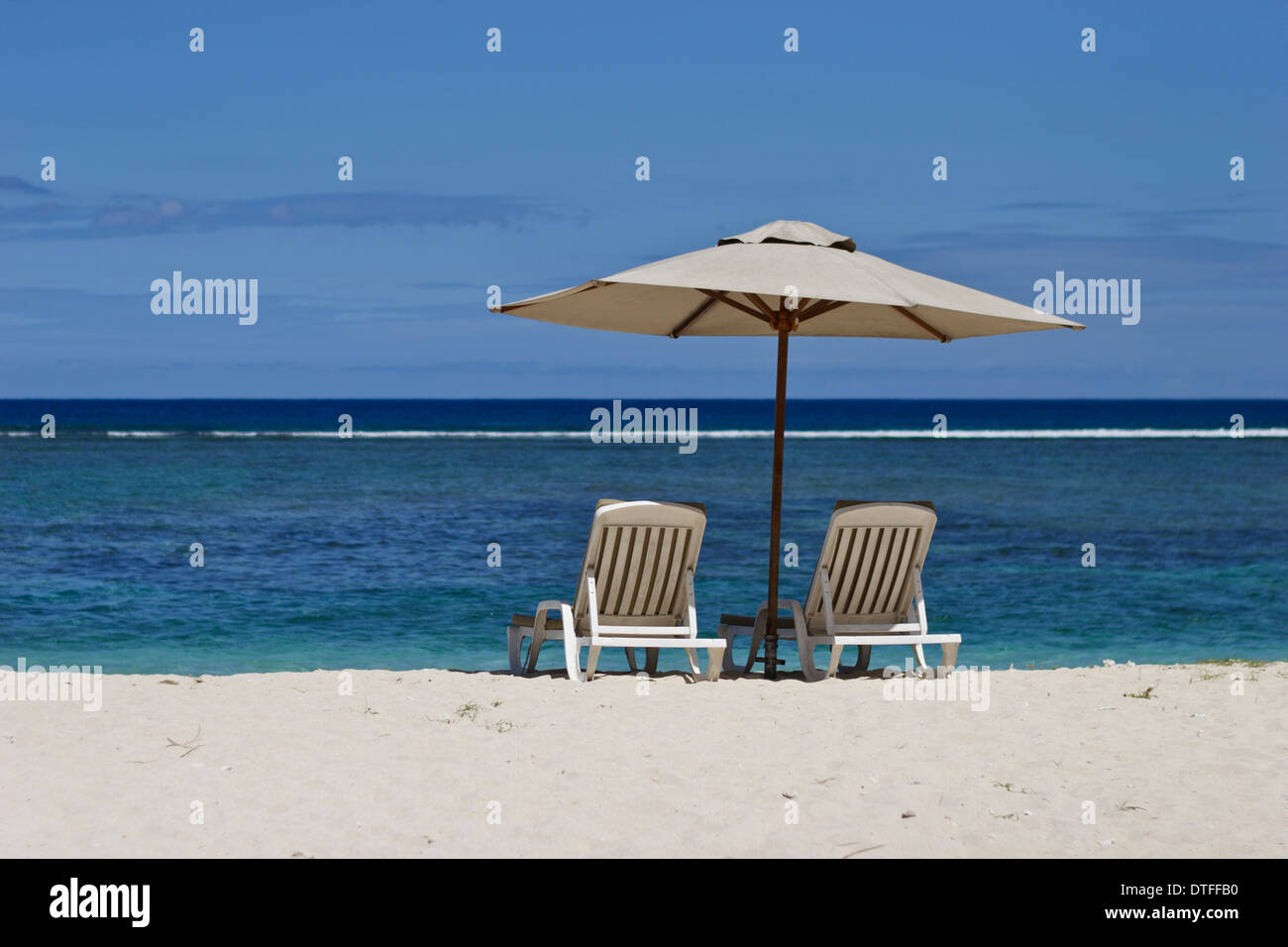Recliners on sandy beach, Mauritius Stock Photo Alamy