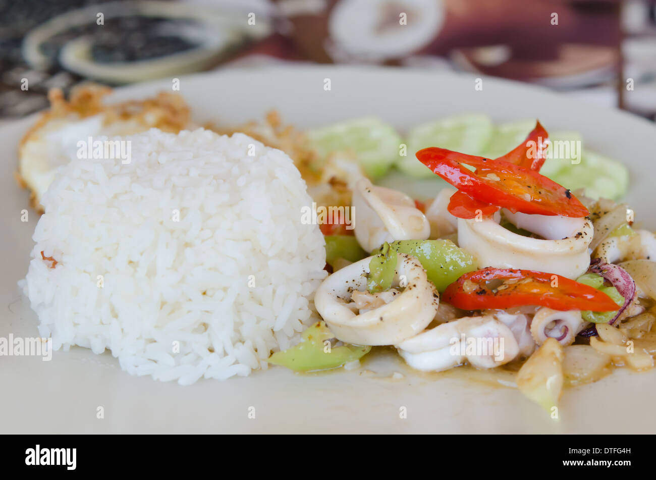 stir fried squid and vegetable served with steamed rice , spicy food