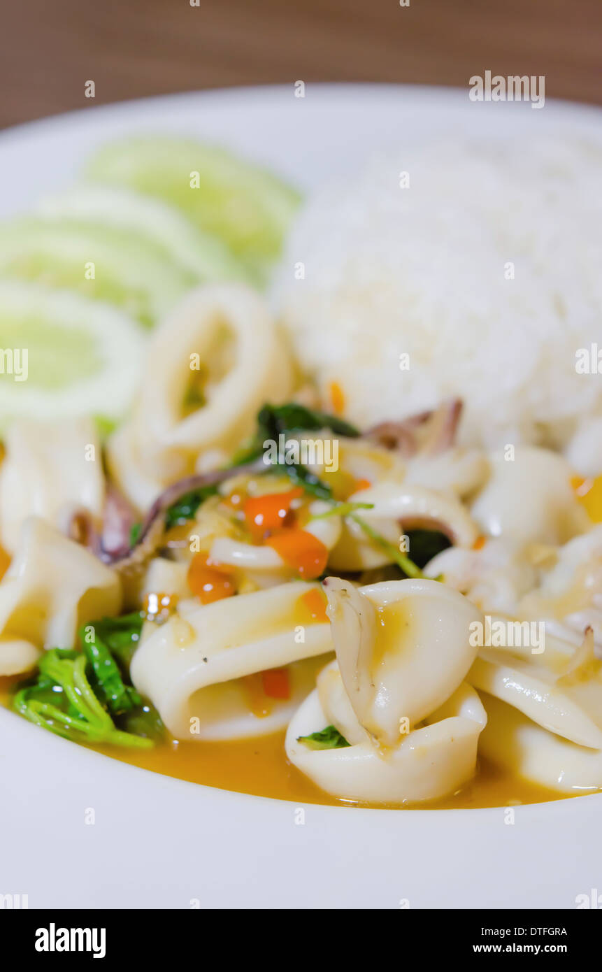 stir fried squid and vegetable served with steamed rice , spicy food