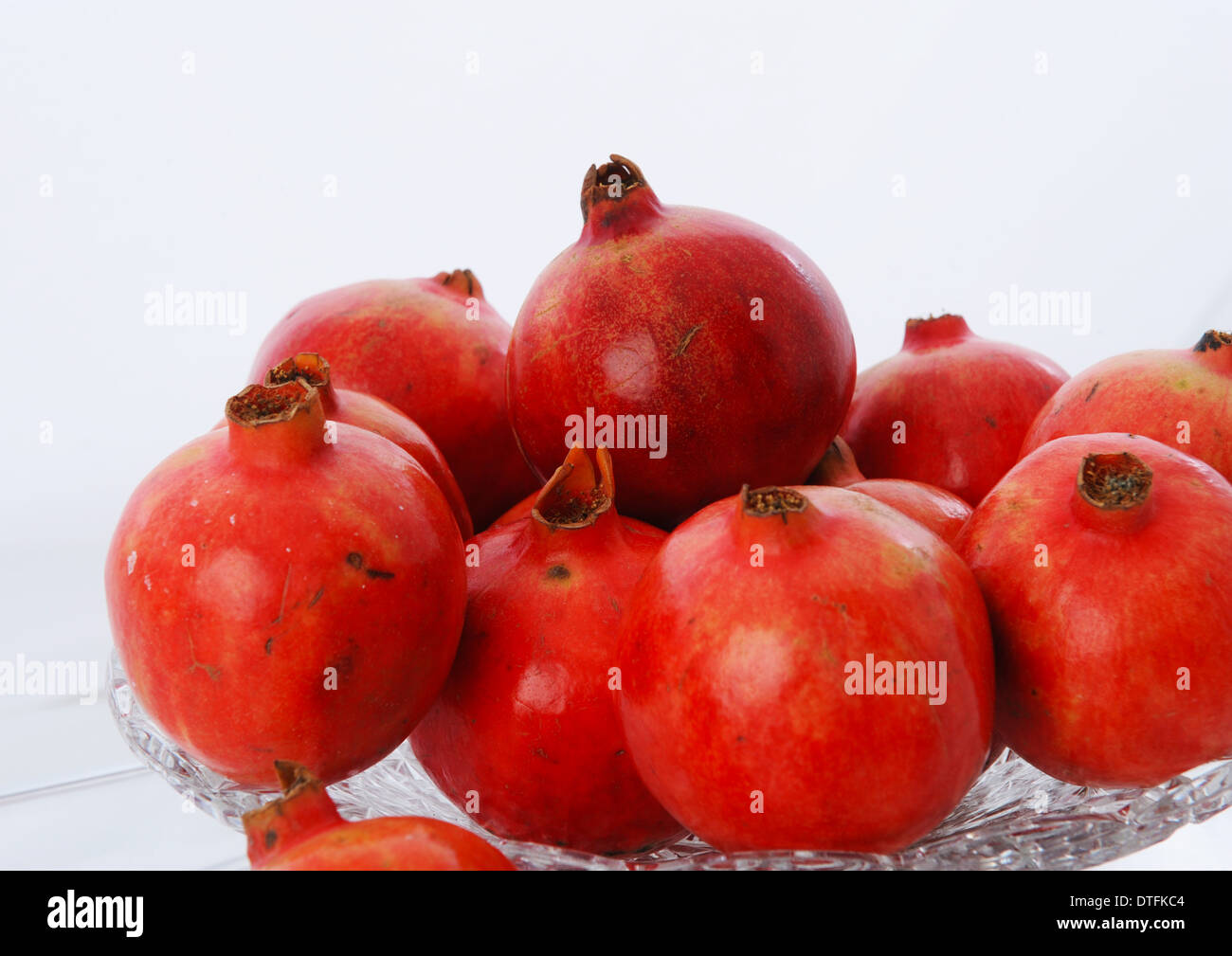 Ripe ruby red pomegranate fruits ready to be peeled. Stock Photo