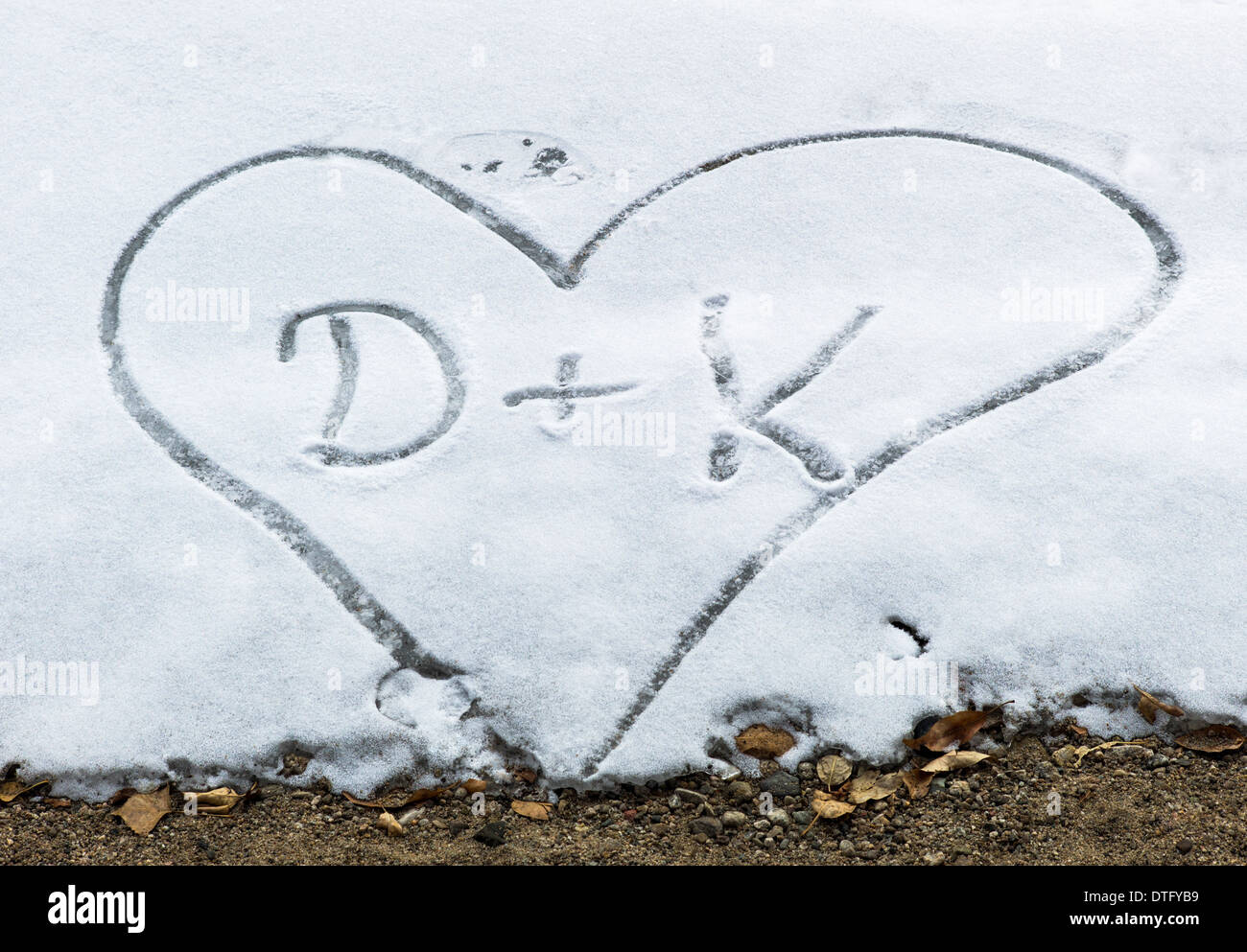 Heart and lover's initials in snow Stock Photo