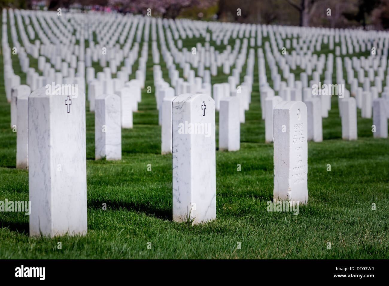 Symmetrical rows of tombs from our brave men and woman of the United States Military, resting at Arlington National Cemetery,in Virginia. Stock Photo