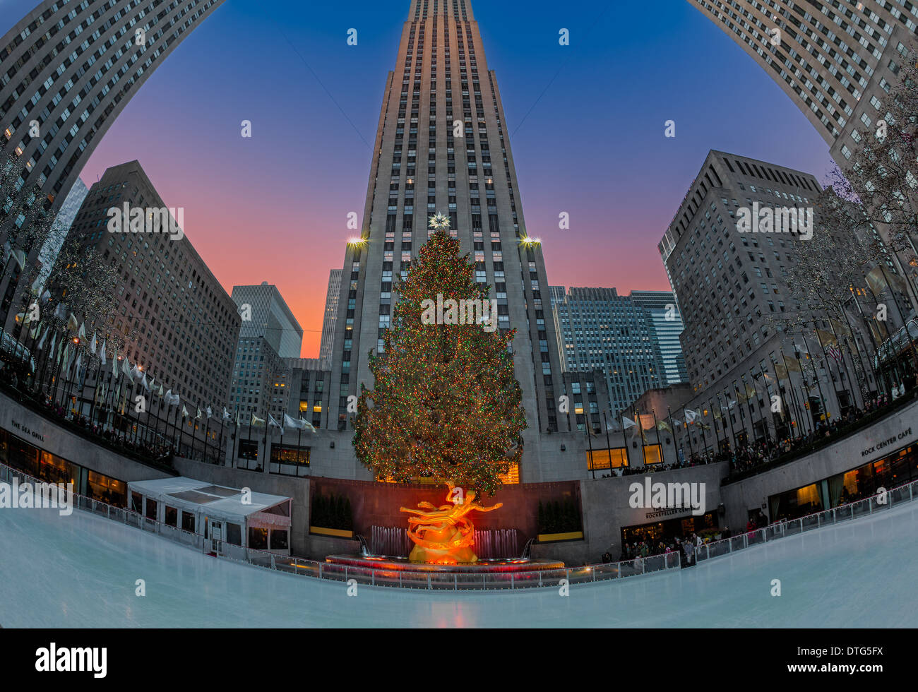Rockefeller Center's lower plaza with the iconic adorned and illuminated Christmas tree and ice skating rink. Stock Photo