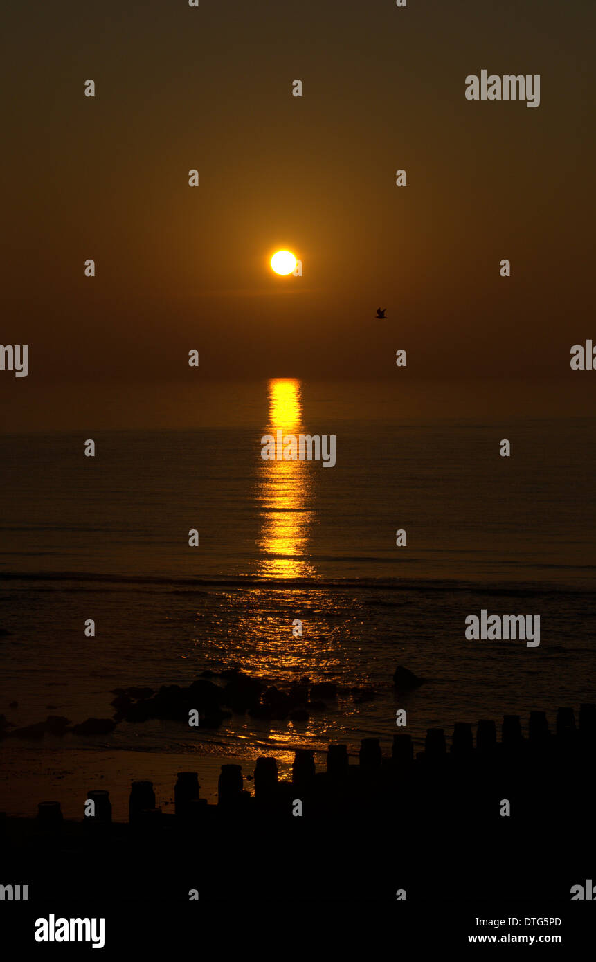 The sun in the sky just after dawn at Eastbourne in Sussex, England, UK Stock Photo