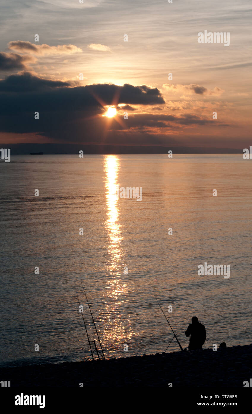 The silhouetted sunset fisherman Stock Photo