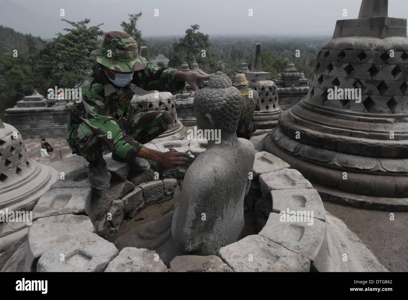 Magelang, Indonesia. 17th Feb, 2014. Indonesia military officers clean the Borobudur temple from the ash volcanic of eruption Kelud Volcano. Mount Kelud ejected 104 million cubic yards of ash as far as 11 miles into the sky in a sudden eruption late Thursday night. Credit:  Sijori Images/ZUMAPRESS.com/Alamy Live News Stock Photo