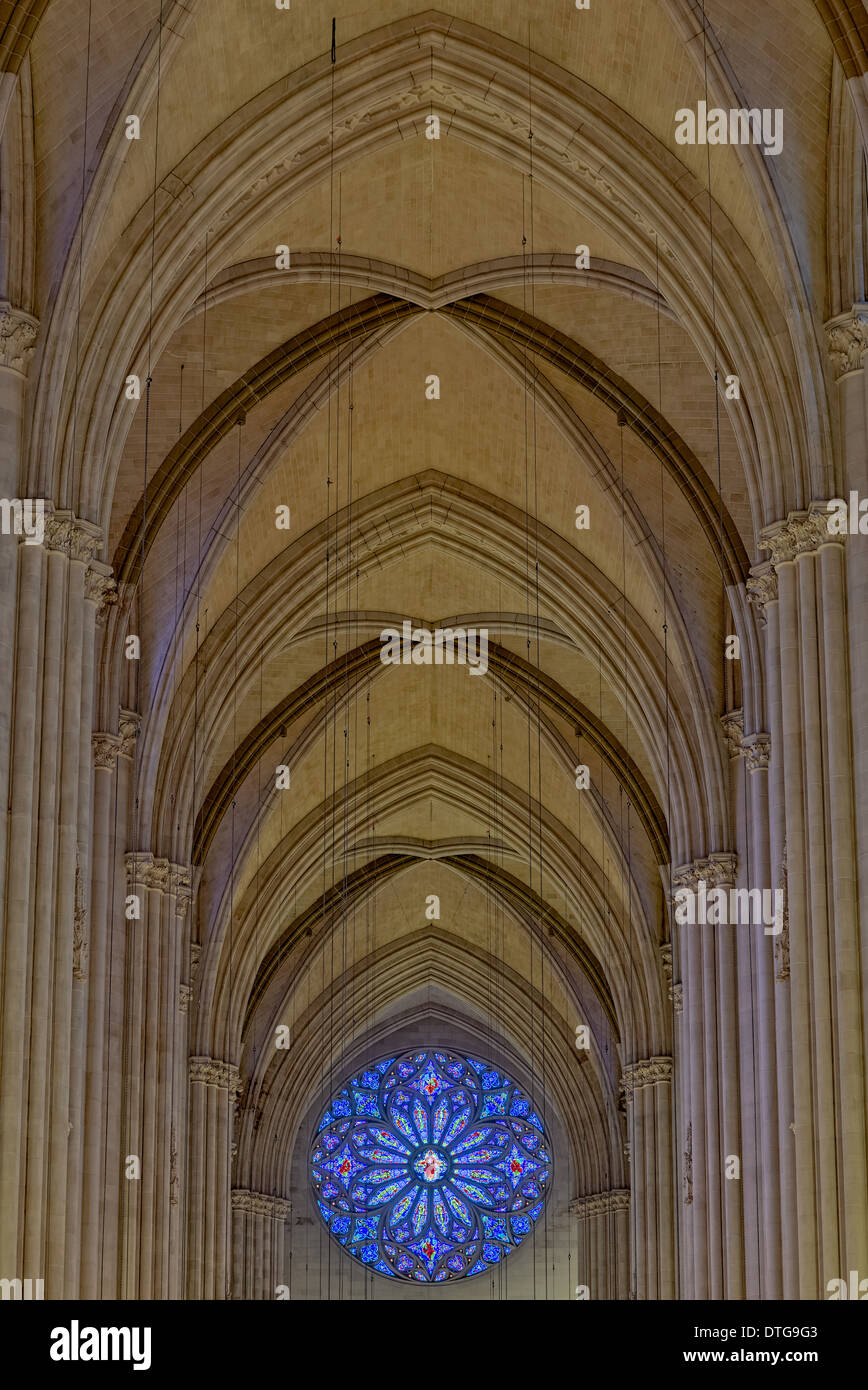 Saint John The Divine Cathedral's massive Gothic Revival arches and Rose Window facing west. Stock Photo