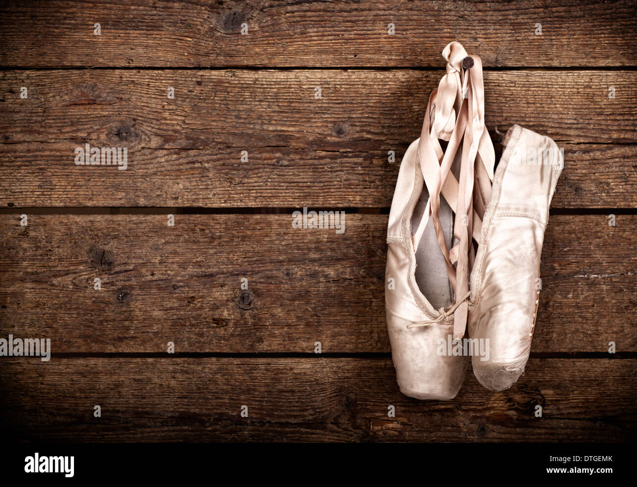 Pink ballet pointe shoes hanging on window Stock Photo by Prostock-studio