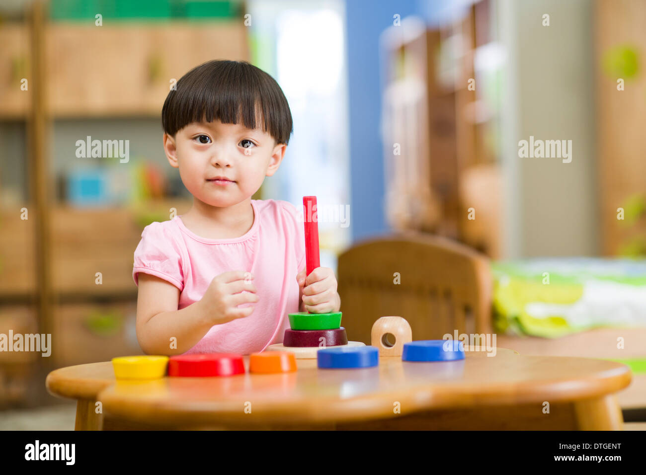 Cute girl playing with toys at home Stock Photo - Alamy