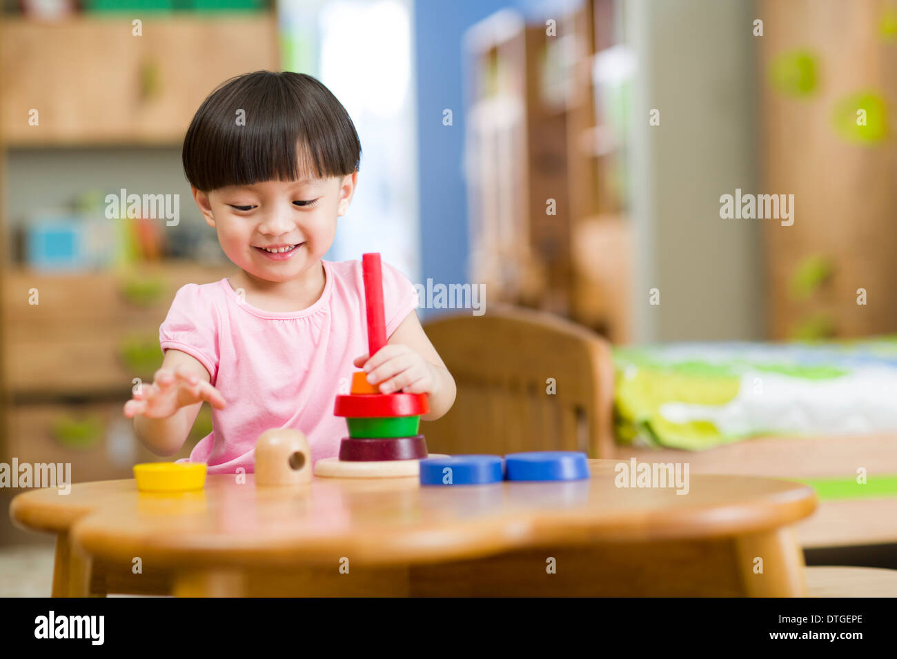 Cute girl playing with toys at home Stock Photo - Alamy