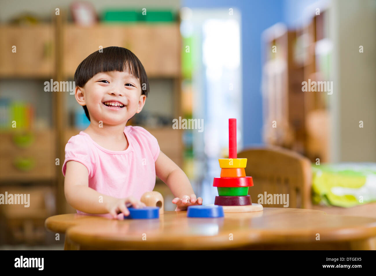Cute girl playing with toys at home Stock Photo - Alamy