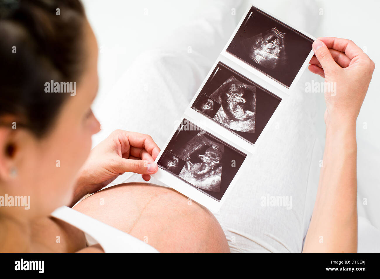 Pregnant woman reviewing baby ultrasound scan Stock Photo