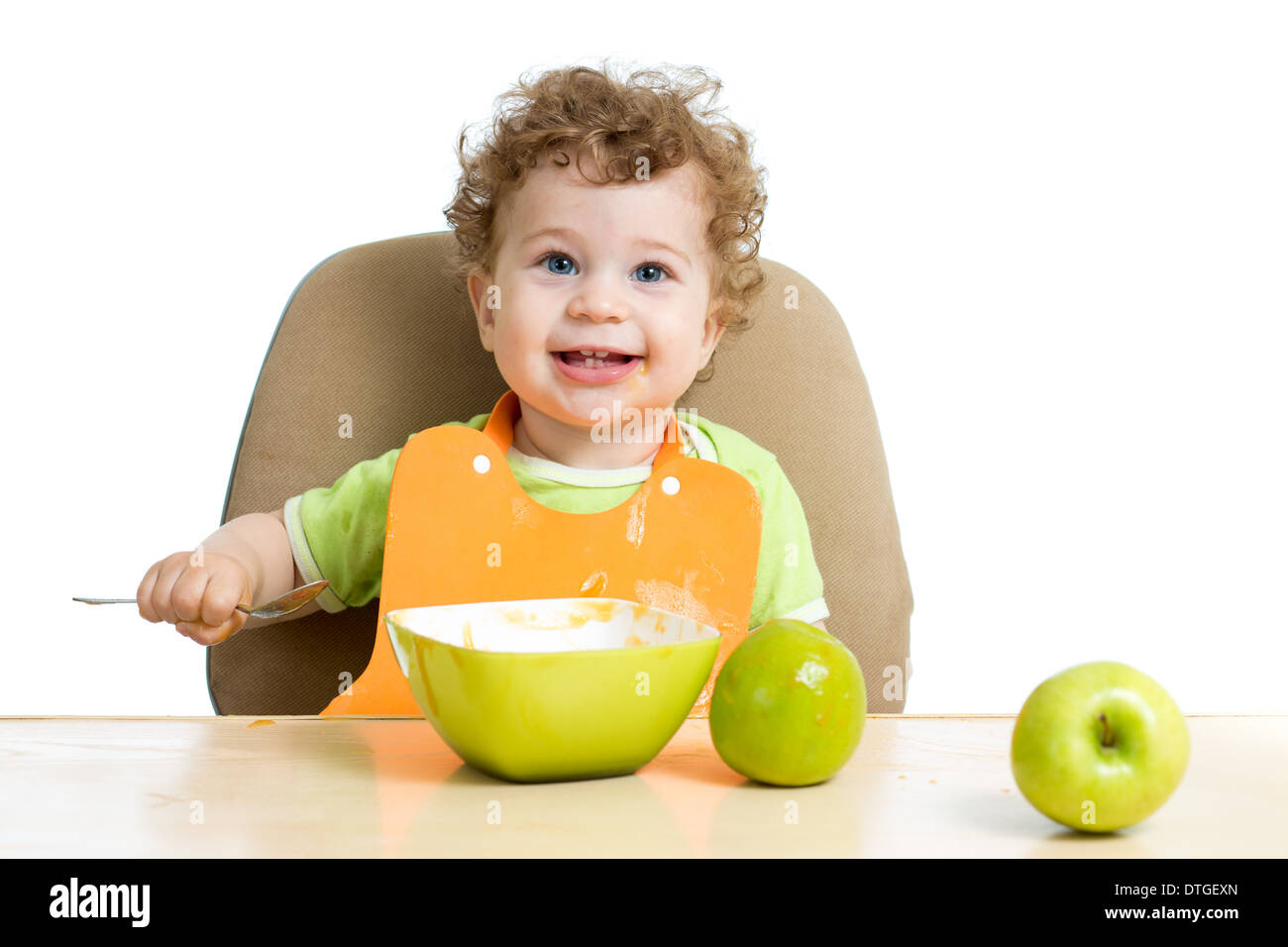 baby eating by himself Stock Photo