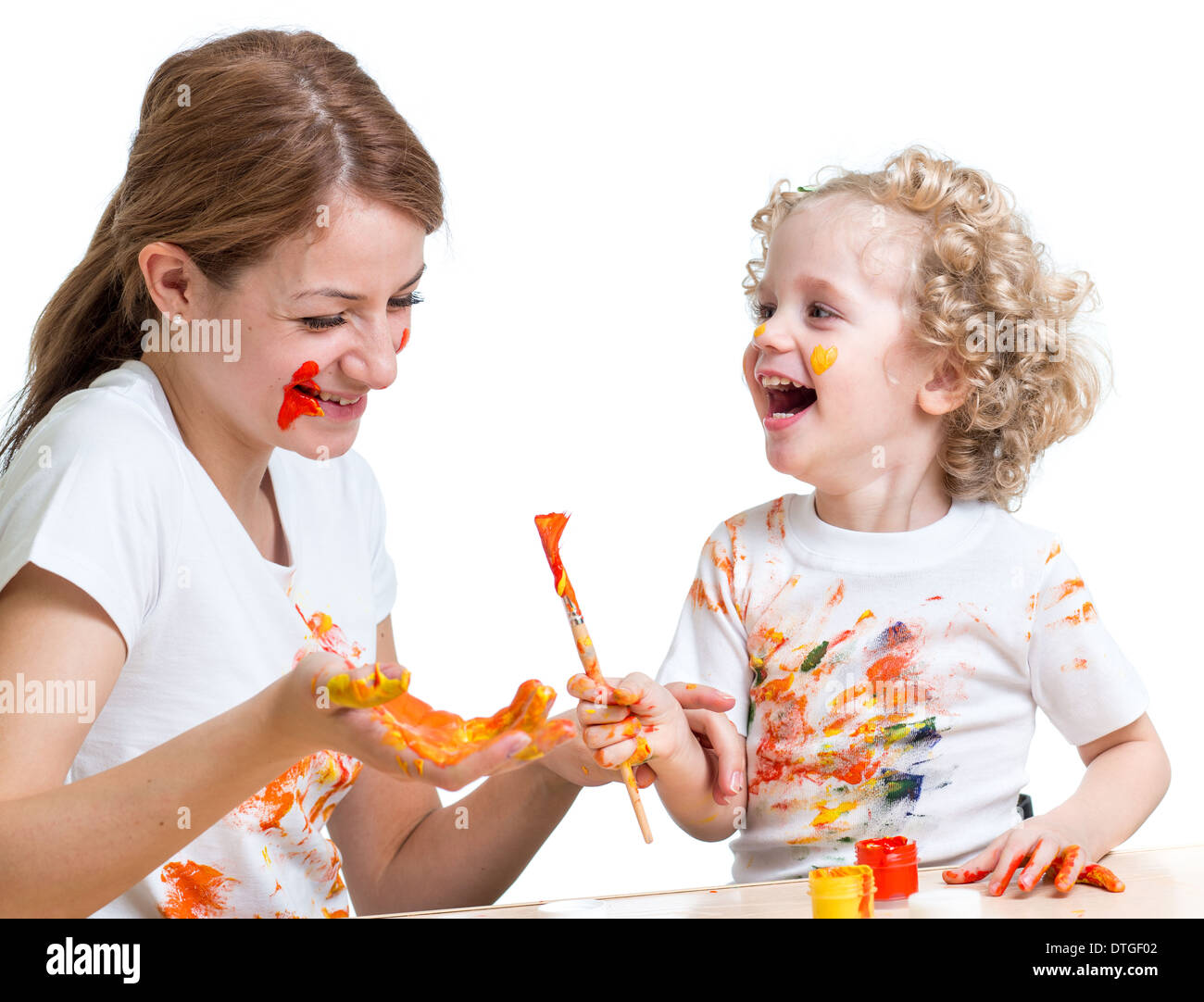 happy mother and kid girl painting together Stock Photo