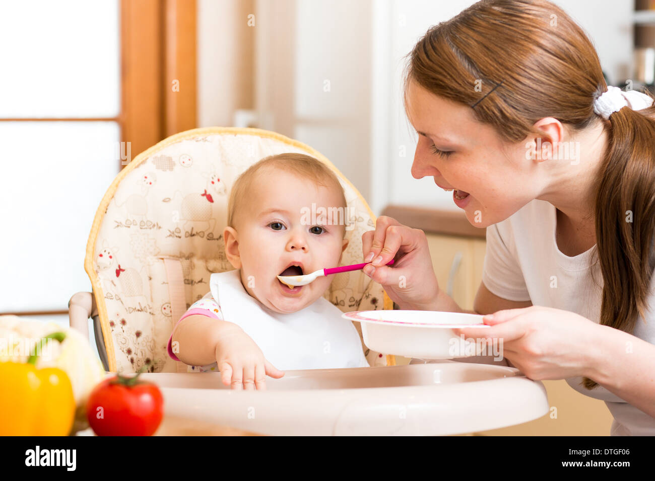 mom-feeds-baby-with-spoon-stock-photo-alamy