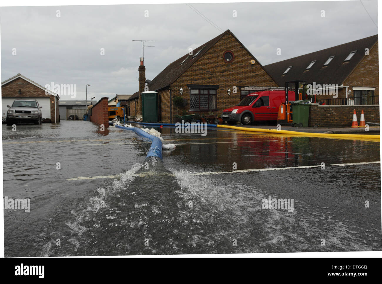 Chertsey, Thames Valley, UK. Flood waters are pumped from business premises . Stock Photo