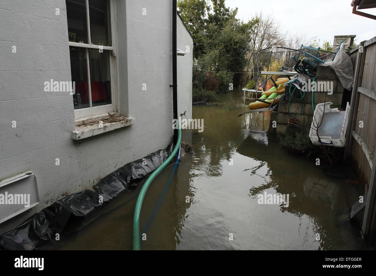 Chertsey, Thames Valley, UK Flood waters surround homes and gardens. Stock Photo