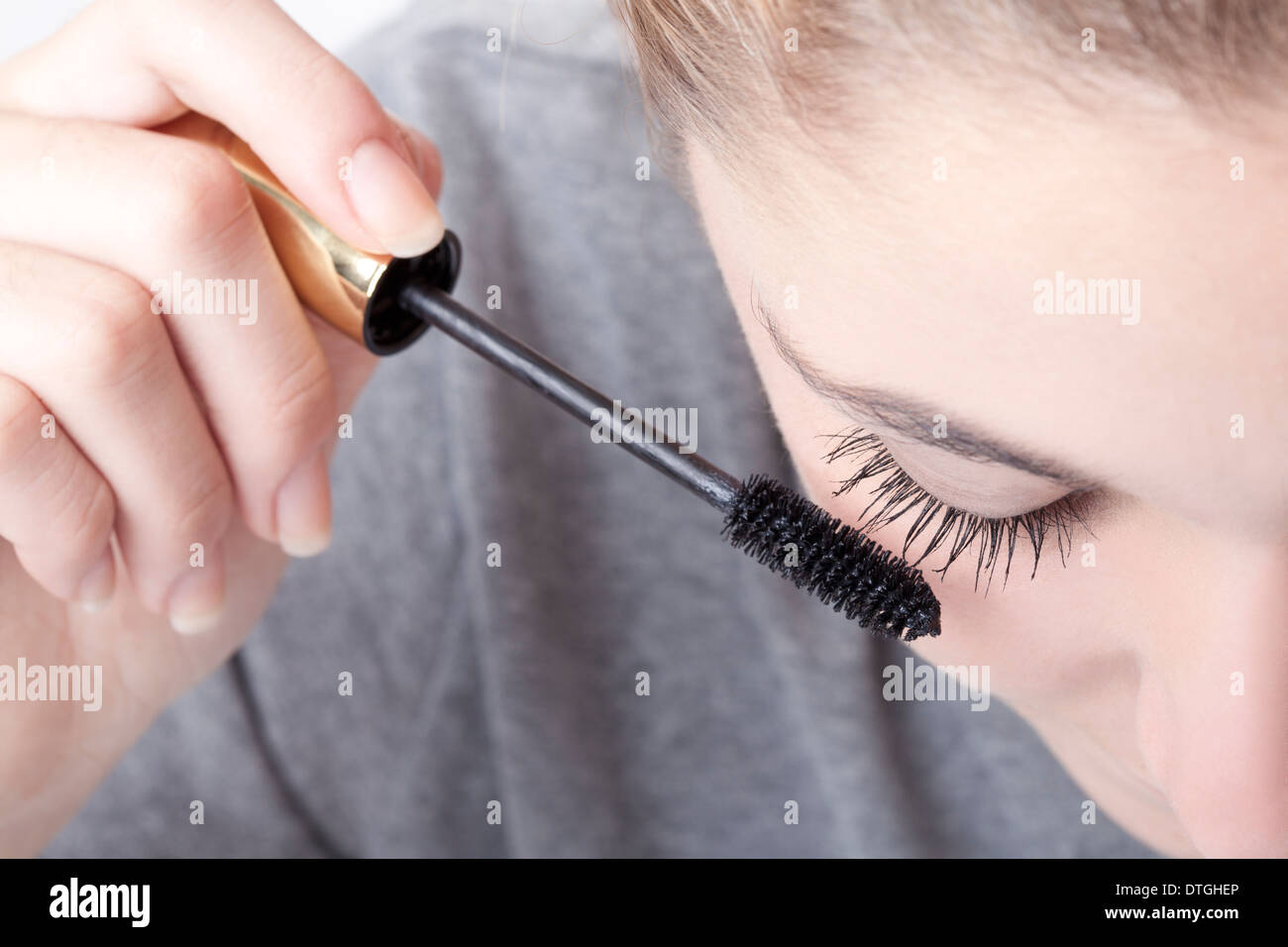 teenage girl applying mascara Stock Photo