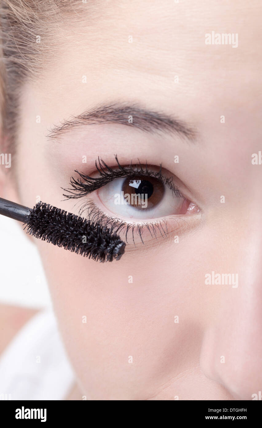 teenage girl applying mascara Stock Photo Alamy