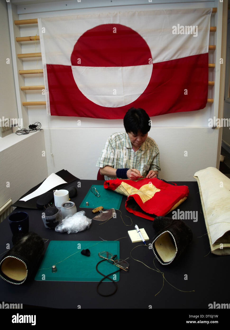 An Inuit women working in a clothing factory for Greenlandic art craft Stock Photo