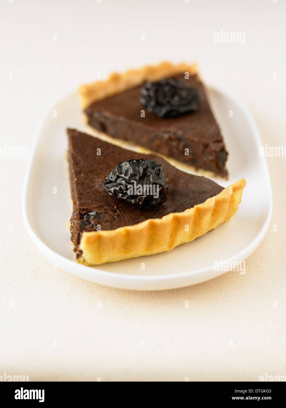 Portions of chocolate and prune tart Stock Photo