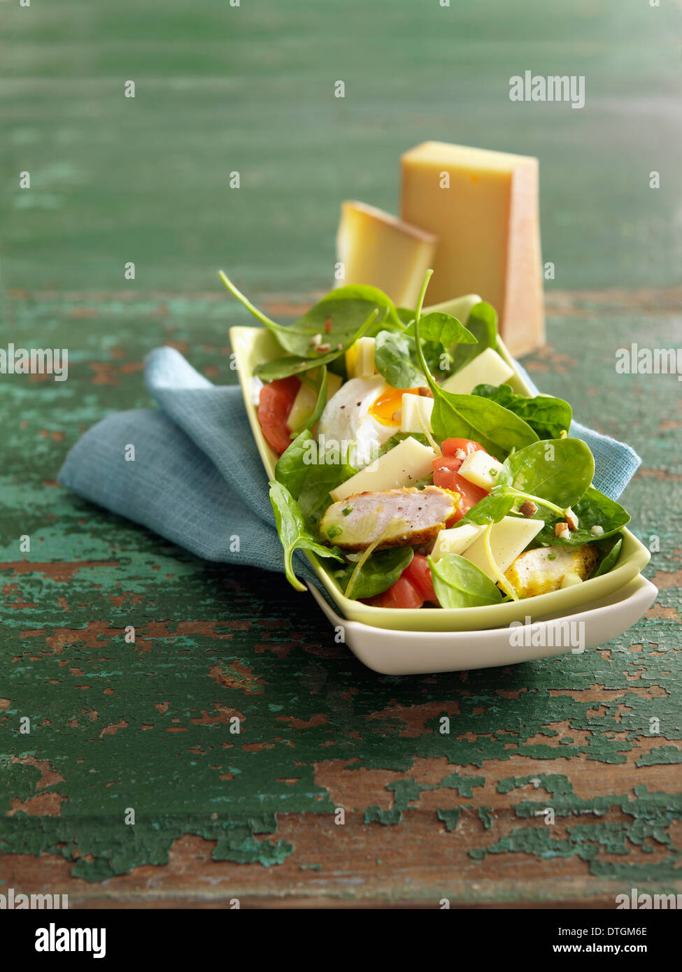 Spinach,chicken,soft-boiled egg and Abondance cheese salad Stock Photo