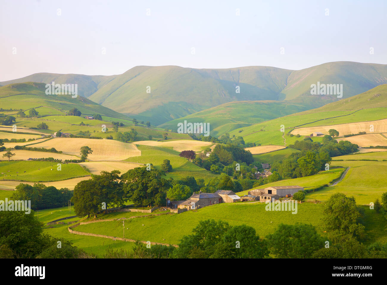 Pastoral Scene of Hill Farms below the Howgill Fells Yorkshire Dales National Park,Cumbria. Hay time Stock Photo
