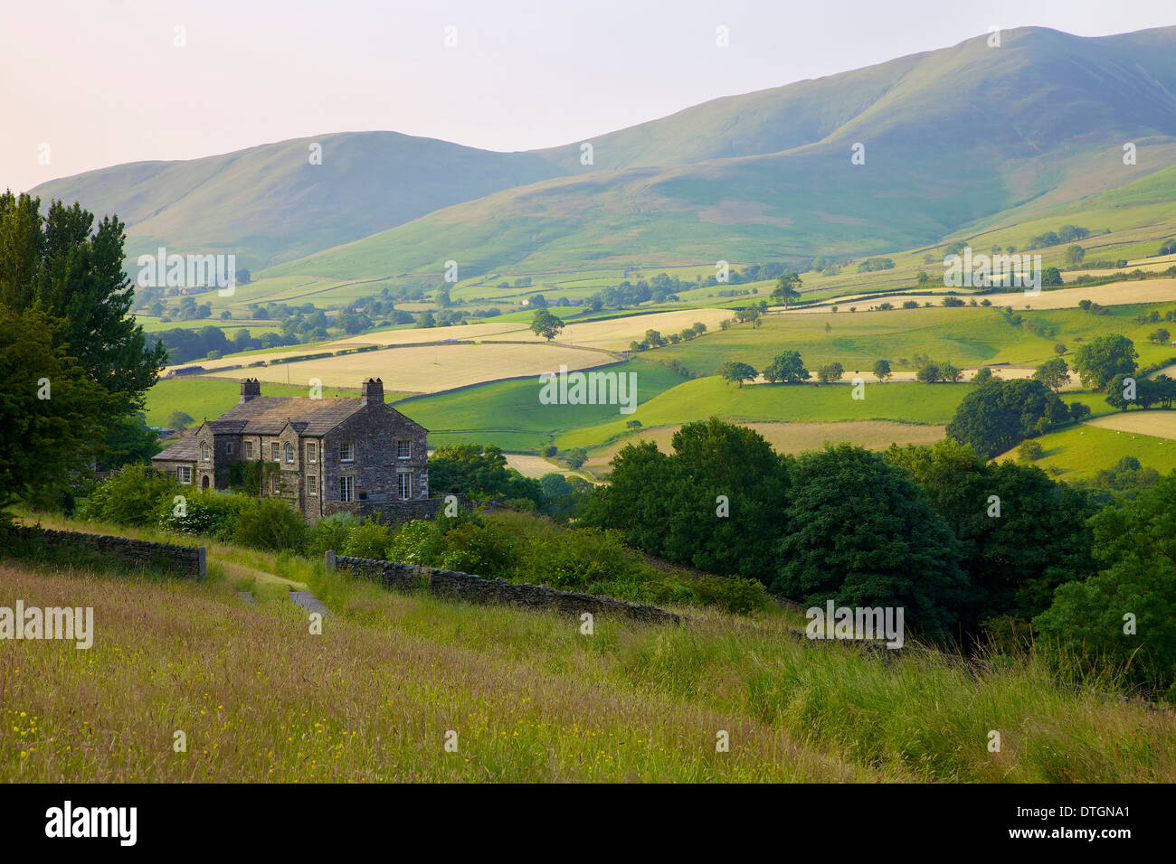 House below the Howgill Fells Yorkshire Dales National Park, Cumbria, England. Hay time. Stock Photo