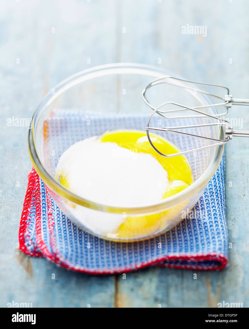 Beating together the egg yolks and the sugar Stock Photo Alamy