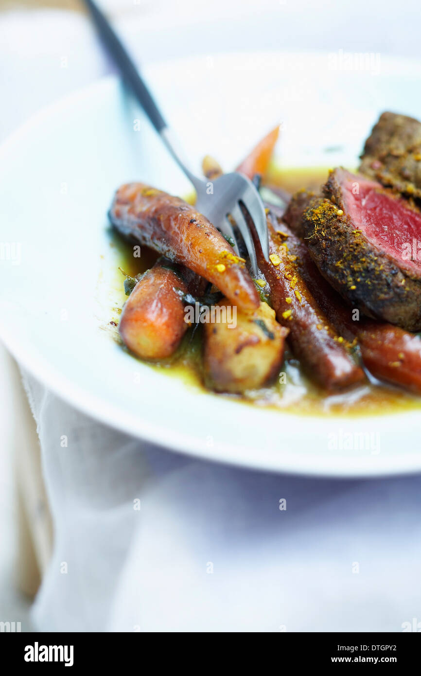 Curry-flavored beef fillet with old-fashioned vegetables Stock Photo