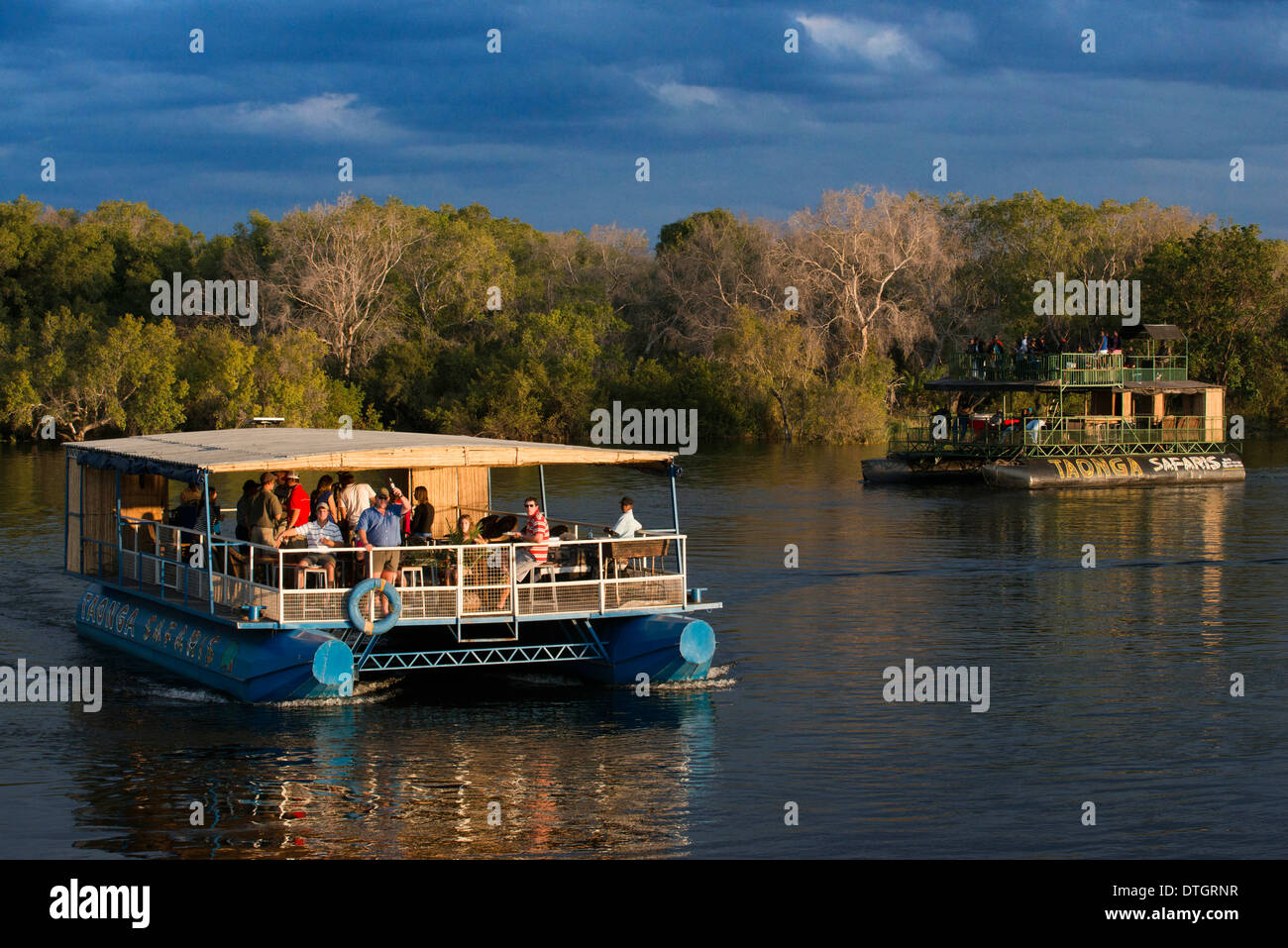 Cruise along the Victoria Falls aboard the ' African Queen'.  Other boats sailing in the Zambezi River. Victoria Falls is famous Stock Photo