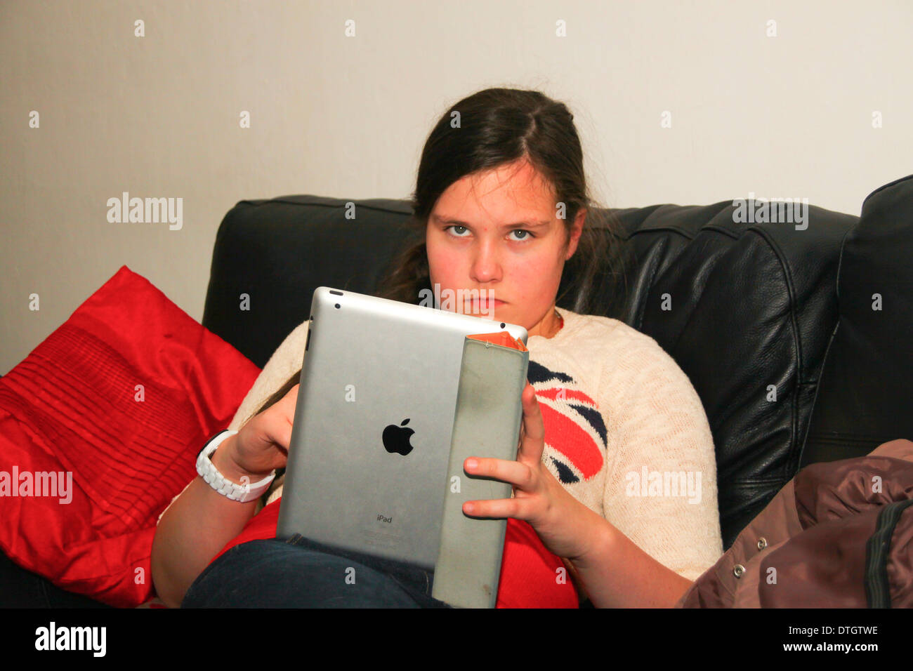 Sullen young girl with iPad tablet Stock Photo