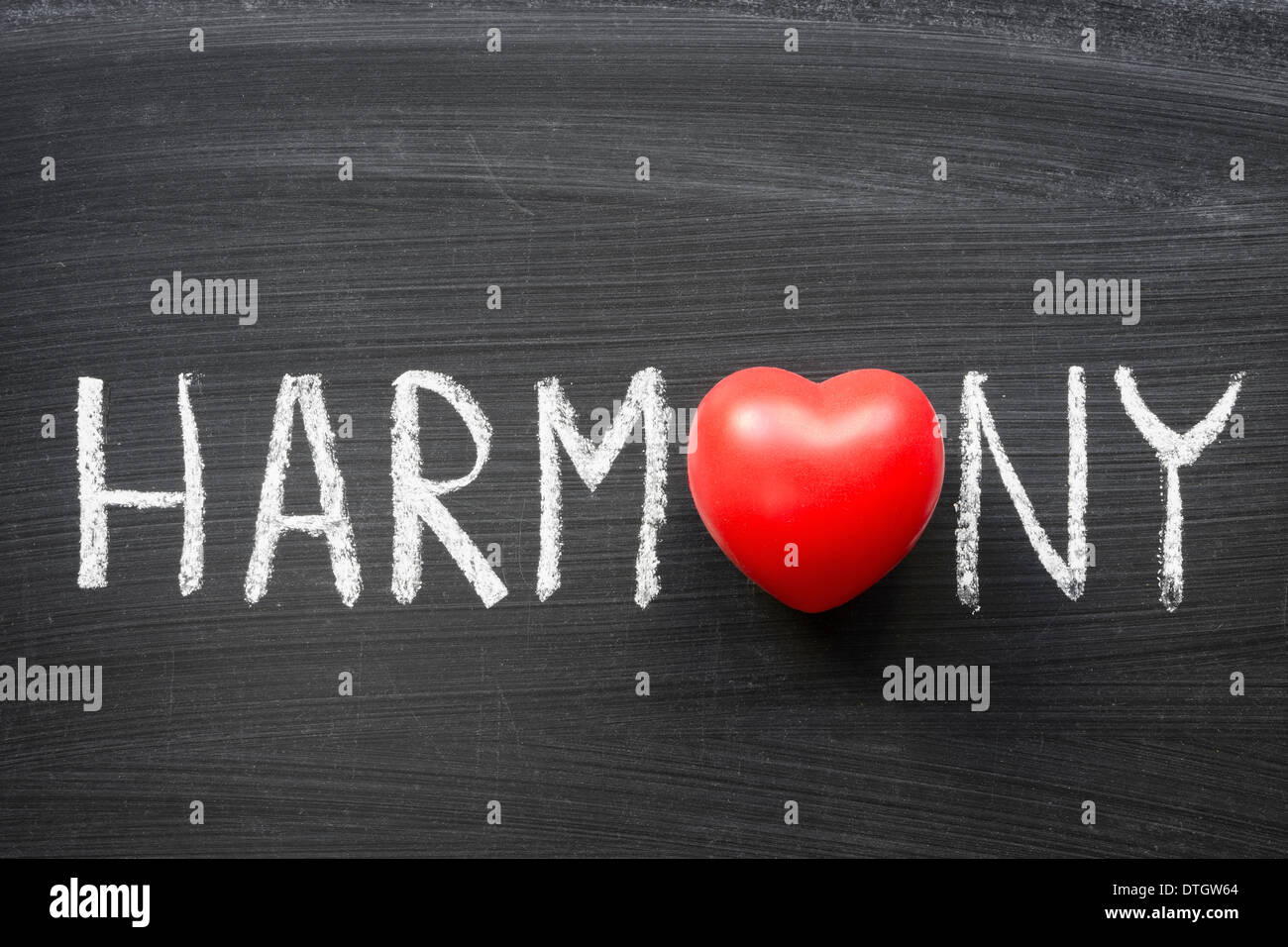 harmony word handwritten on blackboard with heart symbol instead O Stock Photo