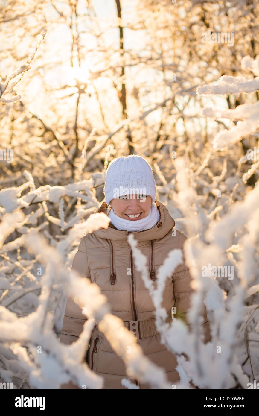 Young girl smiling in the snowy forest Stock Photo - Alamy