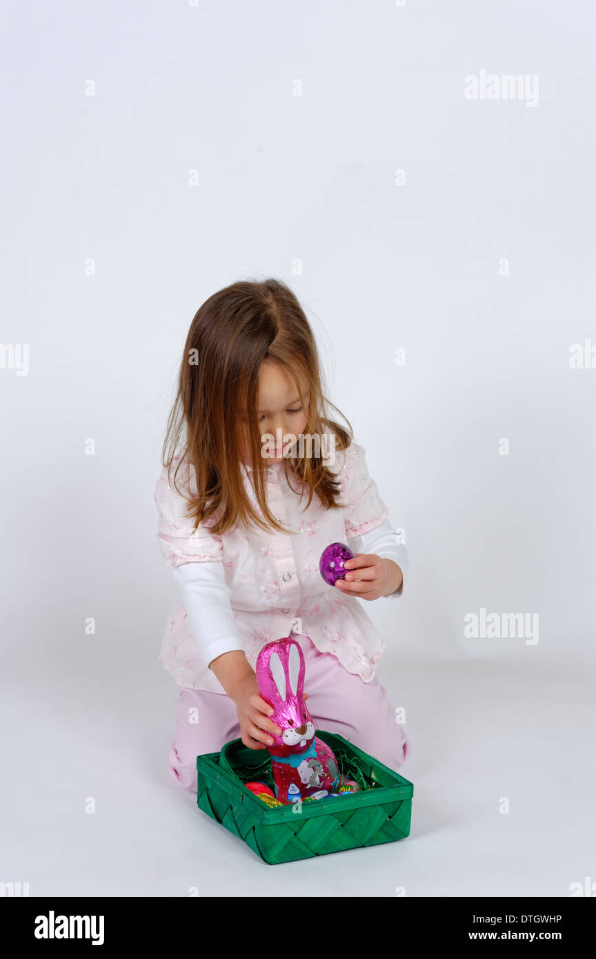 Girl with an Easter basket and a chocolate Easter bunny Stock Photo