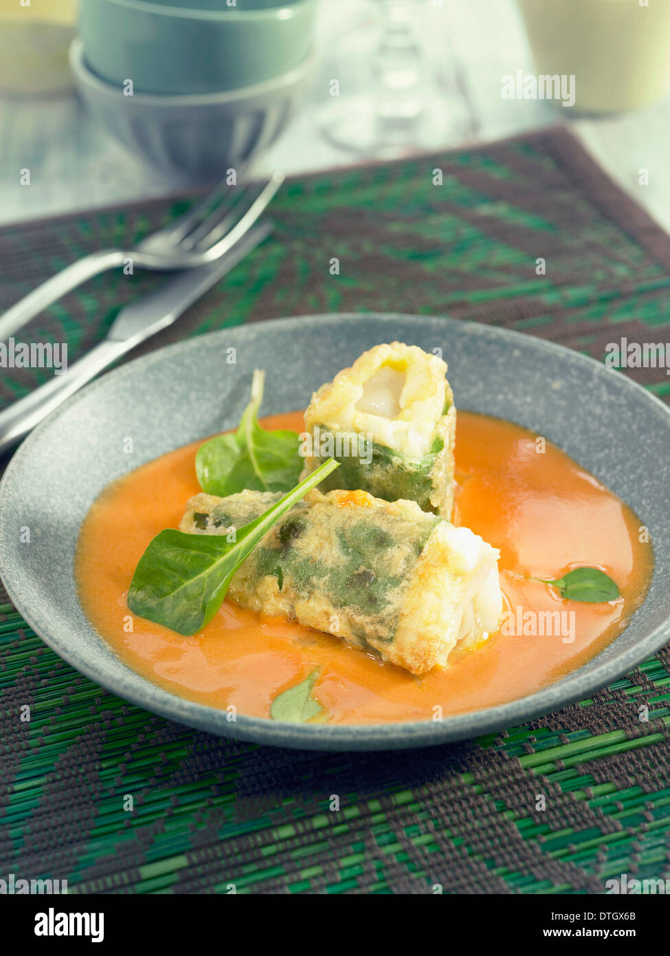 Green peppers stuffed with salt-cod,creamy tomato and Cognac sauce Stock Photo