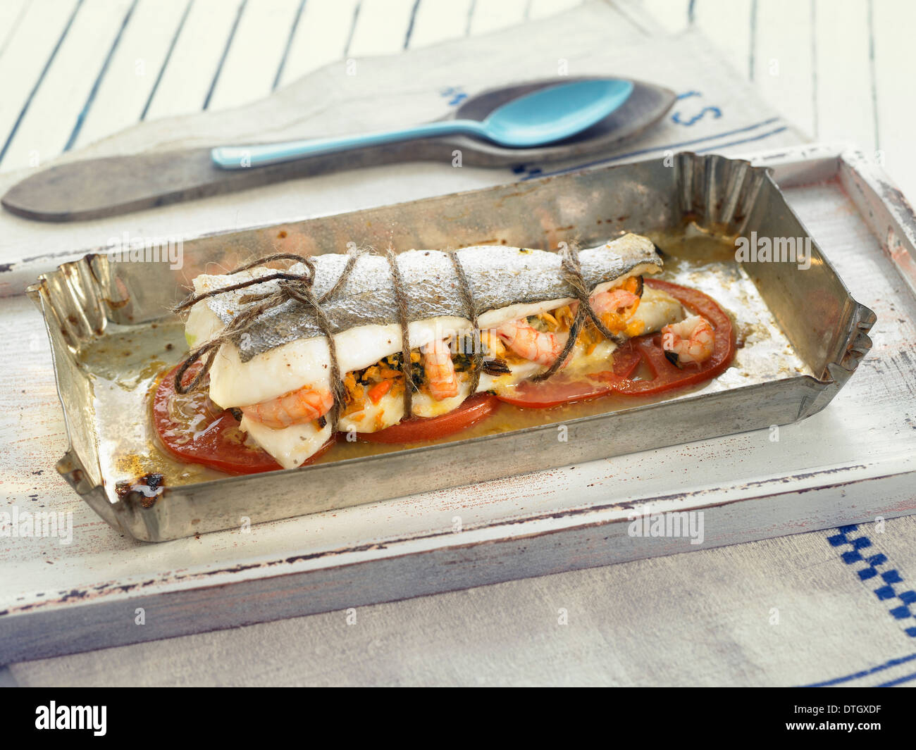 Cod stuffed with shellfish,onions and tomtoes,white wine sauce Stock Photo