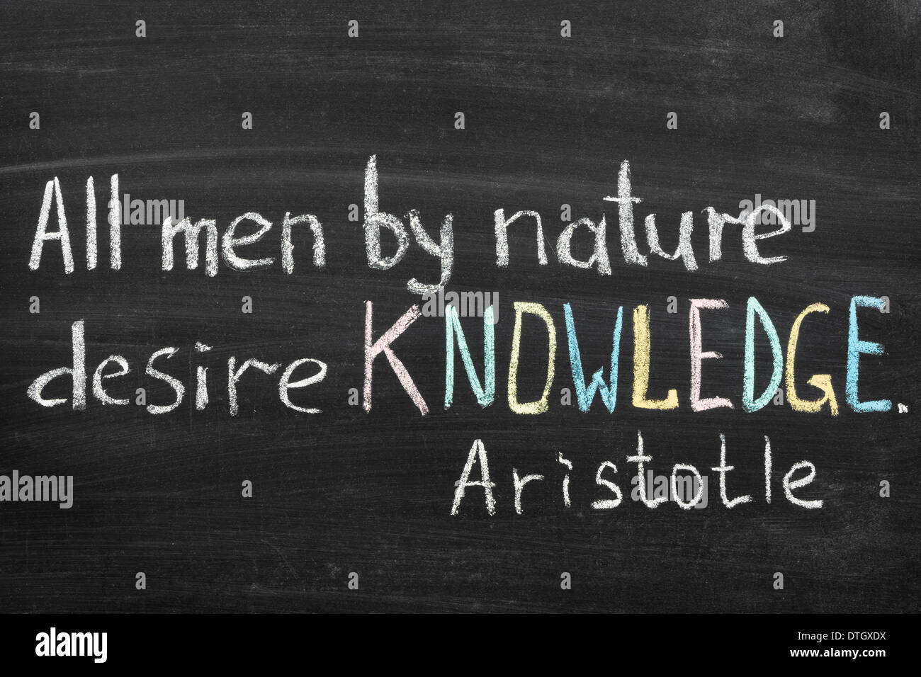 famous Aristotle quote 'All men by nature desire knowledge' handwritten on blackboard Stock Photo
