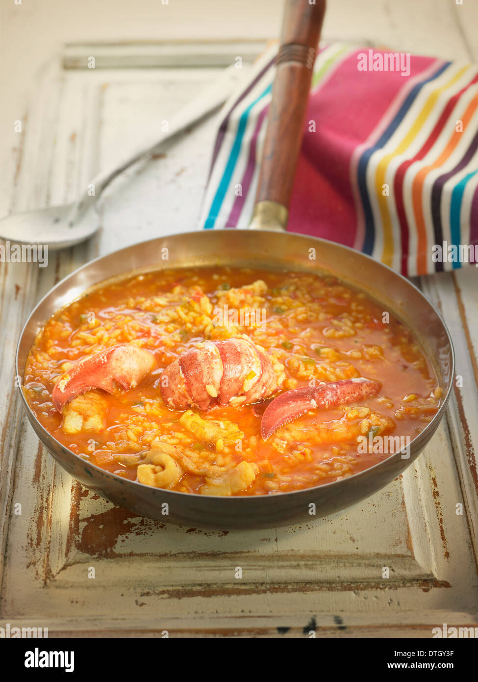 Rice in tomato sauce with lobster,squid and hake Stock Photo
