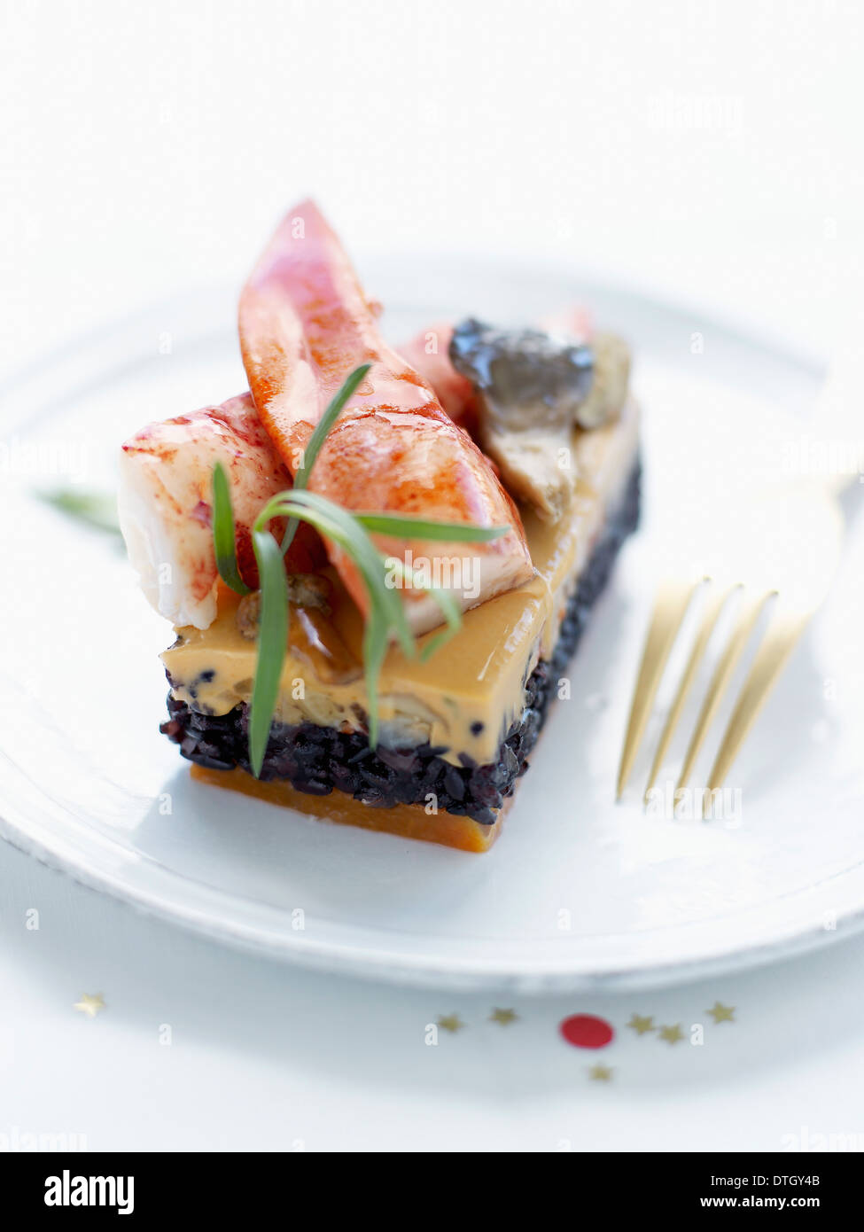 Squid ink risotto,cream of mushroom and lobster terrine Stock Photo