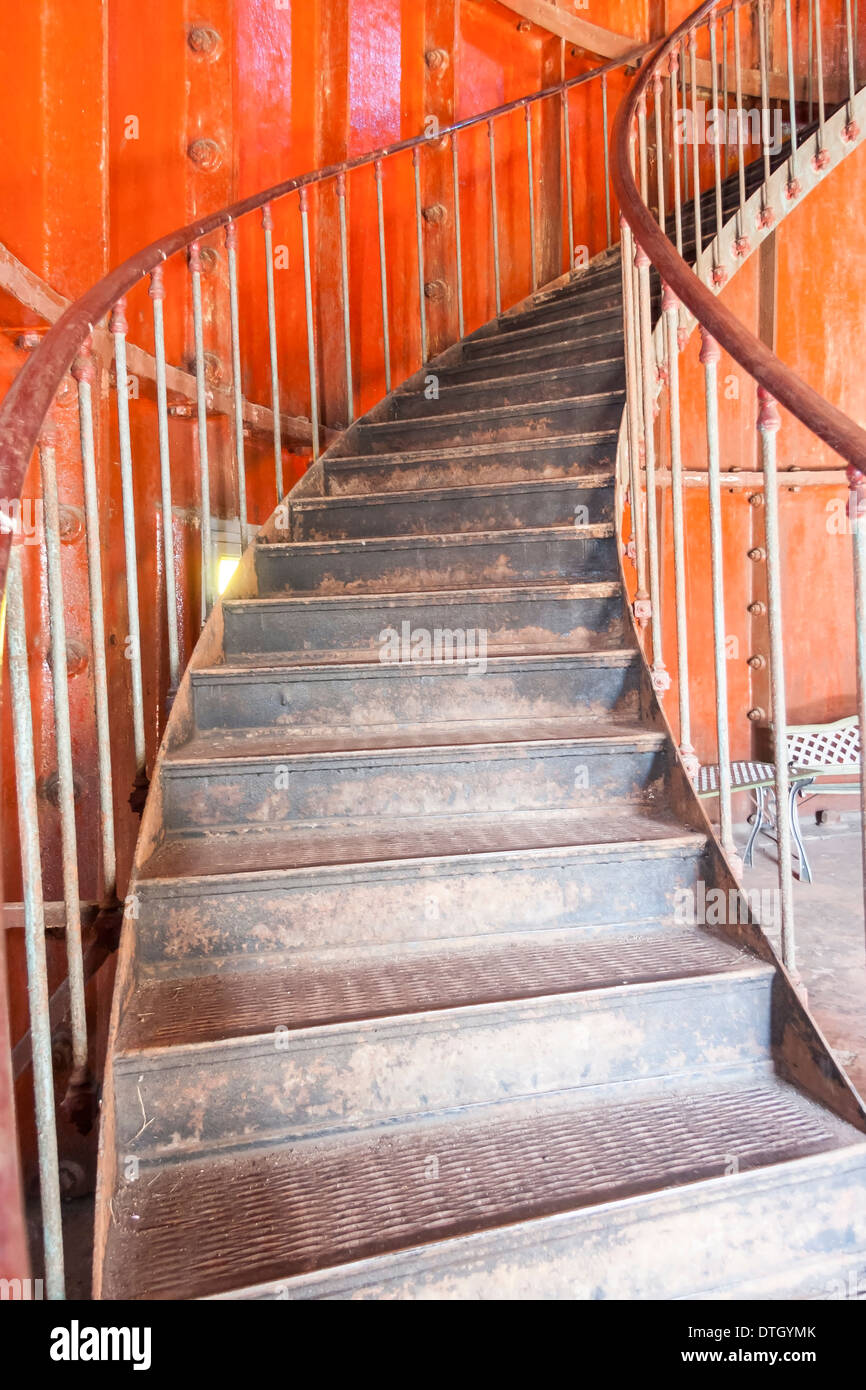 Metal screw stair inside red room Stock Photo