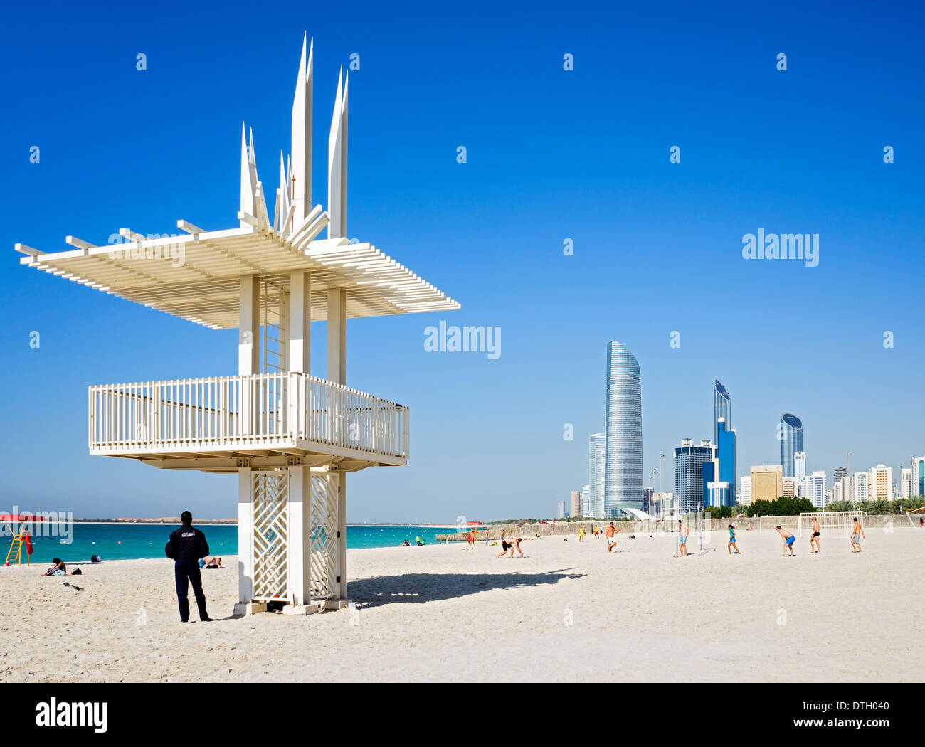 Volleyball game on Corniche beach with skyline in Abu Dhabi United Arab