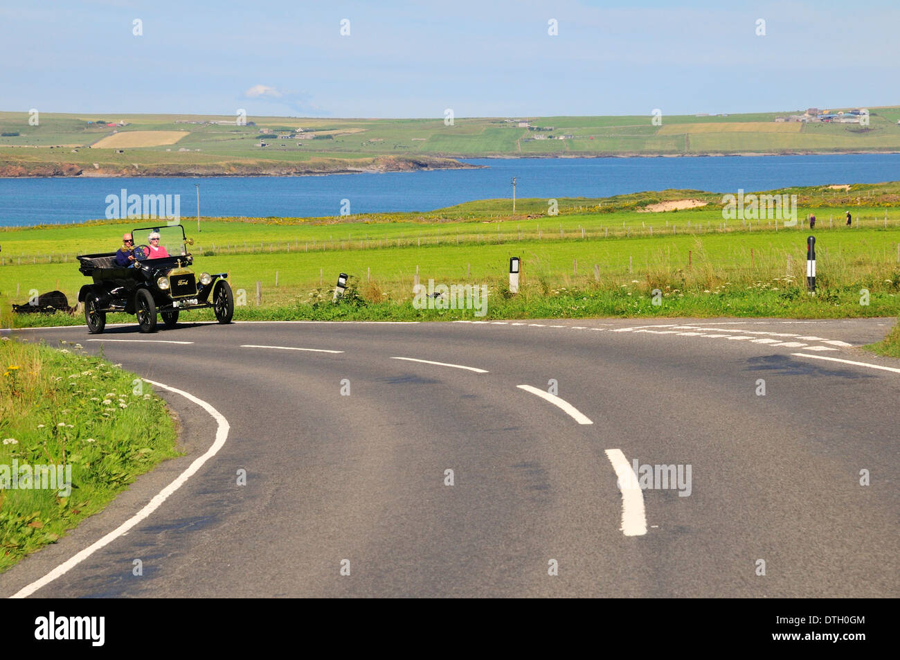 A Tin Lizzie, Ford Model T, on the road at the bay of Scapa Flow, South Ronaldsay, Orkney, Scotland, United Kingdom Stock Photo
