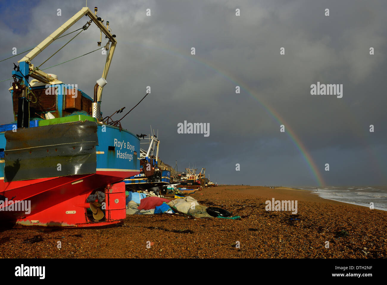 Rainbow over the Stade fishing beach. Hastings old town. East Sussex. UK Stock Photo