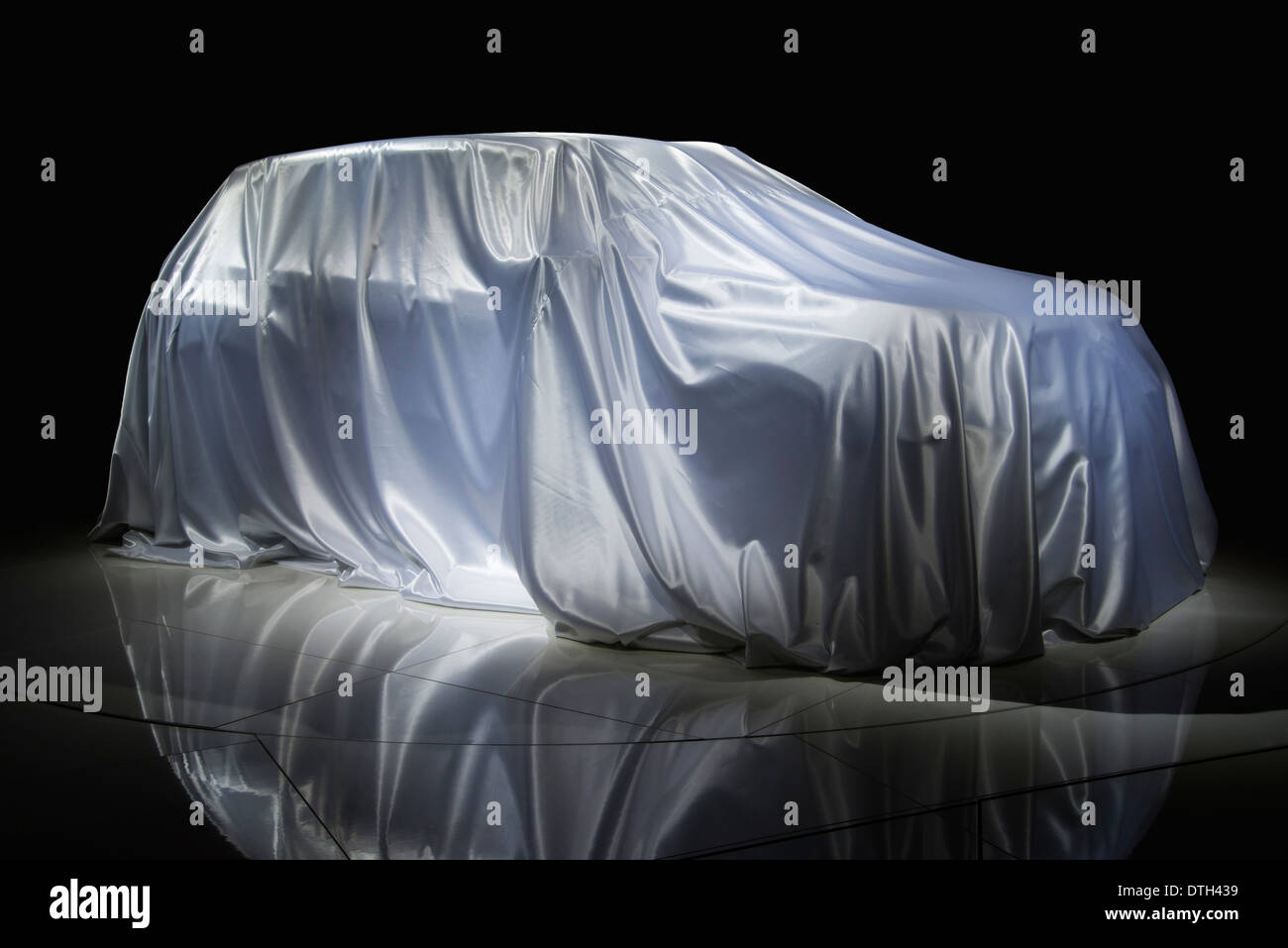 Car is covered with a white cloth. Stock Photo