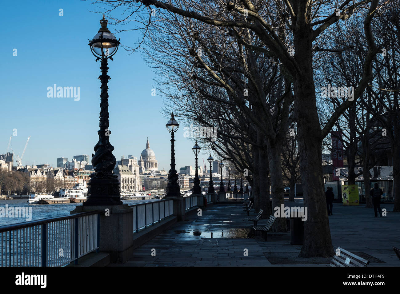 An early morning view looking down the Embankment, which is in shadow, towards St Paul's Cathedral which is in sunlight. Stock Photo