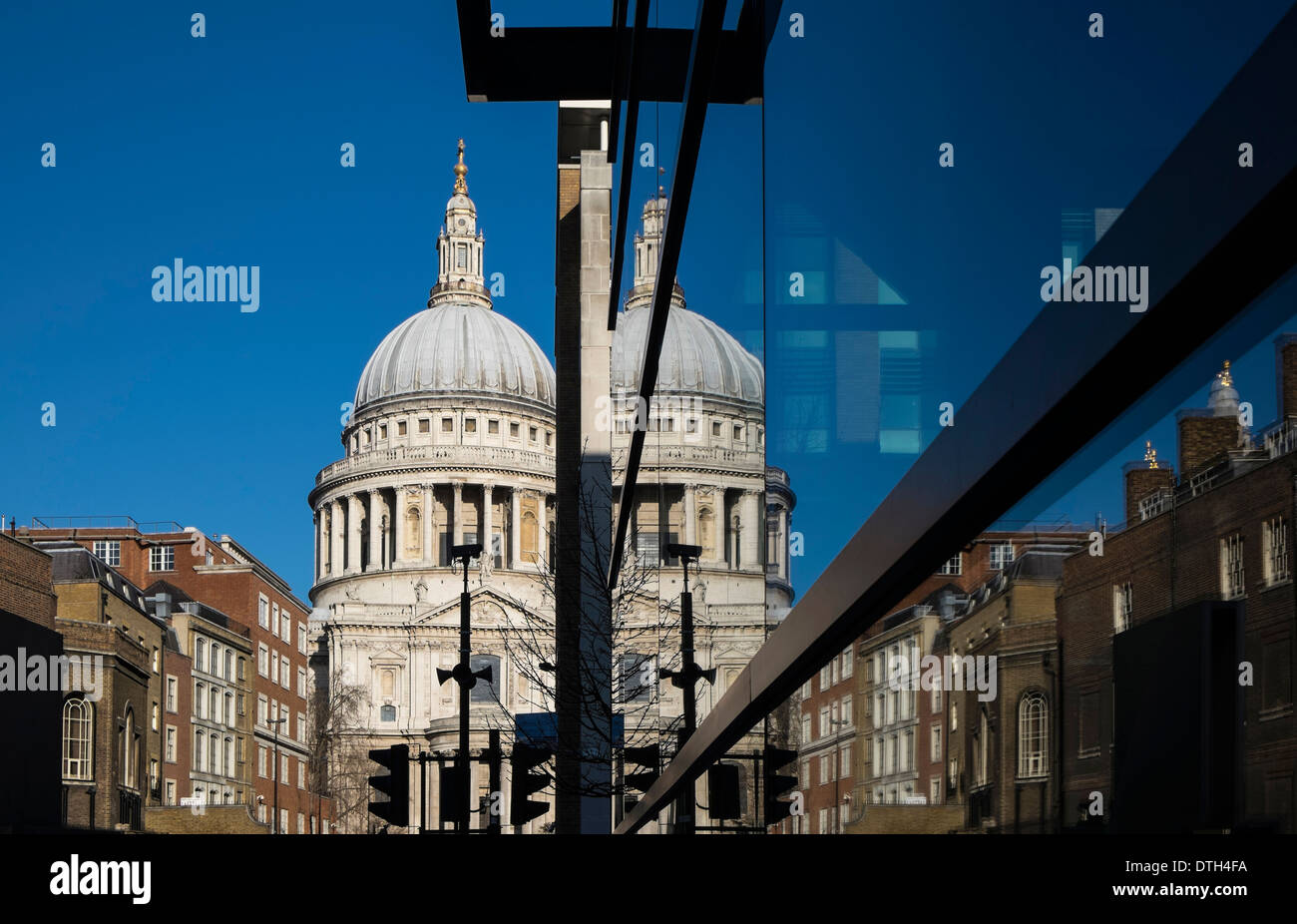 St Paul's Cathedral with a reflection to the right in the glass of an office building. Stock Photo
